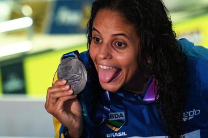 Silver medallist Brazils Etiene Medeiros celebrates during the medals after the final of the womens 50m backstroke event during the swimming competition at the 2019 World Championships at Nambu University Municipal Aquatics Center in Gwangju, South Korea, on July 25, 2019. (Photo by Oli SCARFF / AFP)