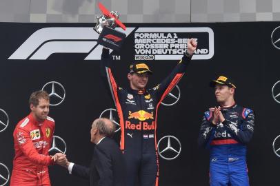 (L-R) Second placed Ferraris German driver Sebastian Vettel, winner Red Bulls Dutch driver Max Verstappen and third placed Toro Rossos Russian driver Daniil Kvyat celebrate on the podium after the German Formula One Grand Prix at the Hockenheim racing circuit on July 28, 2019 in Hockenheim, southern Germany. (Photo by Christof STACHE / AFP)