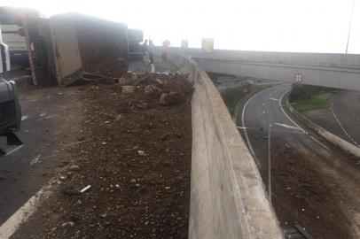 Um caminhão com carga de areia e pedras tombou nesta tarde no acesso da Freeway para a Rodovia do Parque, na zona norte de Porto Alegre. O acidente aconteceu pouco antes das 15h, próximo à Arena do Grêmio.