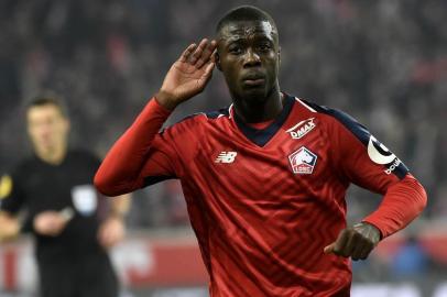 (FILES) In this file photo taken on December 01, 2018 Lilles Ivorian forward Nicolas Pepe celebrates after scoring a goal during the French L1 football match between Lille (LOSC) and Olympique Lyonnais (OL) at the Pierre Mauroy Stadium in Villenueve dAscq. - Arsenal announced the signing of winger Nicolas Pepe from French side Lille on August 1, 2019 for a club-record fee reported to be 80 million euros (£72 million). (Photo by FRANCOIS LO PRESTI / AFP)