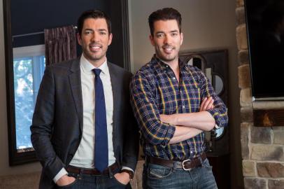 Hosts Drew (L) and Jonathan (R) Scott pose in the new living room of homeowners Katie and Justins recently renovated Toronto home, as seen on Property Brothers.