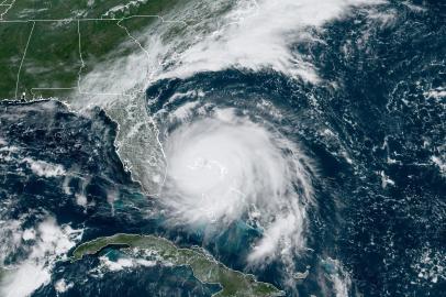 This satellite image obtained from NOAA/RAMMB, shows Tropical Storm Dorian as it approaches the Bahamas at 15:30 UTC on September 2, 2019. - Hurricane Dorian battered the Bahamas with ferocious wind and rain on Sunday, the monstrous Category 5 storm wrecking towns and homes as it churned on an uncertain path toward the US coast where hundreds of thousands were ordered to evacuate. Packing sustained winds of 165 miles per hour (270 kph) with a towering 18 to 23 foot (5 to 7 metre) storm surge, Dorian crashed over the Abacos Islands, in the northwest Bahamas, as the strongest storm ever to hit the Caribbean chain. 