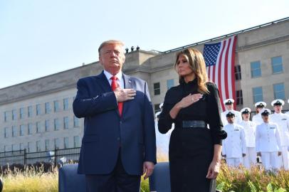 US President Donald Trump and First Lady Melania Trump listen to the national anthem during a ceremony marking the 18th anniversary of the 9/11 attacks, on September 11, 2019, at the Pentagon in Washington, DC. (Photo by Nicholas Kamm / AFP)