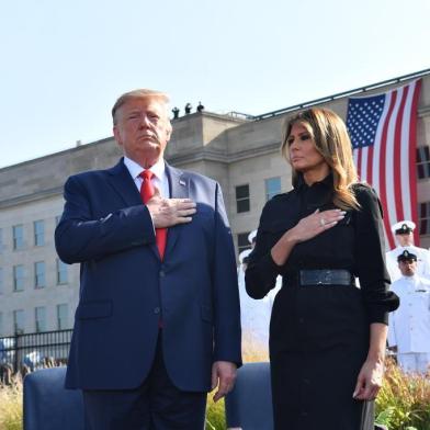 US President Donald Trump and First Lady Melania Trump listen to the national anthem during a ceremony marking the 18th anniversary of the 9/11 attacks, on September 11, 2019, at the Pentagon in Washington, DC. (Photo by Nicholas Kamm / AFP)