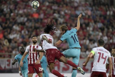 Tottenham Hotspurs English striker Harry Kane (R) heads the ball with Olympiakos Portuguese defender Ruben Semedo during the UEFA Champions League Group B football match Olympiakos vs Tottenham Hotspur on September 18, 2019 at the Georgios Karaiskakis Stadium in Athens. (Photo by LOUISA GOULIAMAKI / AFP)