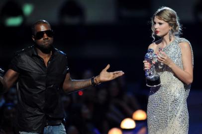 NEW YORK - SEPTEMBER 13:  Kanye West takes the microphone from Taylor Swift and speaks onstage during the 2009 MTV Video Music Awards at Radio City Music Hall on September 13, 2009 in New York City.  (Photo by Kevin Mazur/WireImage) 