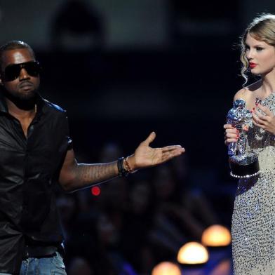 NEW YORK - SEPTEMBER 13:  Kanye West takes the microphone from Taylor Swift and speaks onstage during the 2009 MTV Video Music Awards at Radio City Music Hall on September 13, 2009 in New York City.  (Photo by Kevin Mazur/WireImage) 