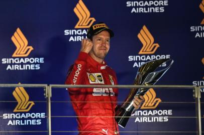 Ferraris German driver Sebastian Vettel celebrates his victory on the podium after the Formula One Singapore Grand Prix night race at the Marina Bay Street Circuit in Singapore on September 22, 2019. (Photo by Mohd RASFAN / AFP)