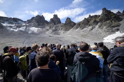 People take part in a ceremony to mark the death of the Pizol glacier (Pizolgletscher) on September 22, 2019 above Mels, eastern Switzerland. - In a study earlier this year, researchers of ETH technical university in Zurich determined that more than 90 percent of Alpine glaciers will disappear by 2100 if greenhouse gas emissions are left unchecked. (Photo by Fabrice COFFRINI / AFP)