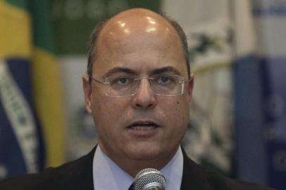 Rio de Janeiros Governor Wilson Witzel (C) gestures during a press conference in Rio de Janeiro, Brazil, on September 23, 2019, after eight-year-old Agatha Sales Felix died during a police operation at the Alemao complex slum. - Felix was killed by a stray bullet during a confrontation between alleged drug traffickers and police officers on September 21. (Photo by MAURO PIMENTEL / AFP)