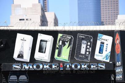 A sign advertises Juul vaping products in Los Angeles, California, September 17, 2019. - New York became the second US state to ban flavored e-cigarettes September 17, following several deaths linked to vaping that have raised fears about a product long promoted as less harmful than smoking. (Photo by Robyn Beck / AFP)