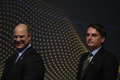 Rio de Janeiro's Governor Wilson Witzel (L) and Brazilian President Jair Bolsonaro attend the ceremony marking the assembly of the parts of Brazil's new Navy submarine Humaita (SBR-2), at the Itaguai Navy Complex in Rio de Janeiro, Brazil, on October 11, 2019. (Photo by MAURO PIMENTEL / AFP)