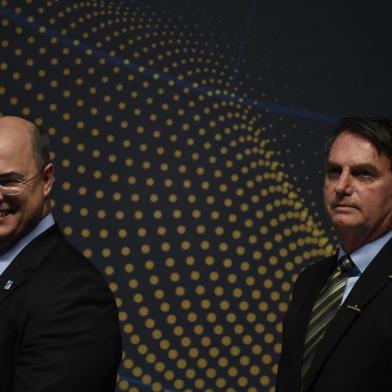 Rio de Janeiro's Governor Wilson Witzel (L) and Brazilian President Jair Bolsonaro attend the ceremony marking the assembly of the parts of Brazil's new Navy submarine Humaita (SBR-2), at the Itaguai Navy Complex in Rio de Janeiro, Brazil, on October 11, 2019. (Photo by MAURO PIMENTEL / AFP)