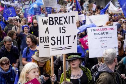 Demonstrators hold placards as they take part in a march by the Peoples Vote organisation in central London on October 19, 2019, calling for a final say in a second referendum on Brexit. - Thousands of people march to parliament calling for a Peoples Vote, with an option to reverse Brexit as MPs hold a debate on Prime Minister Boris Johnsons Brexit deal. (Photo by Niklas HALLEN / AFP)