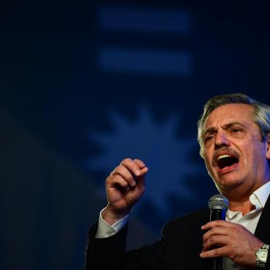 Argentinas presidential candidate for the Frente de Todos party Alberto Fernandez addresses supporters after being elected as new president, at the headquarters of the party in Buenos Aires after polls closed in Argentinas general election on October 27, 2019. - Peronist candidate Alberto Fernandez won Argentinas presidential election in the first round on Sunday, official results showed, bringing to an end the crisis-plagued rule of market-friendly incumbent Mauricio Macri. (Photo by RONALDO SCHEMIDT / AFP)