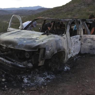 Members of the Lebaron family watch the burned car where part of the nine murdered members of the family were killed and burned during an gunmen ambush on Bavispe, Sonora mountains, Mexico, on November 5, 2019. - US President Donald Trump offered Tuesday to help Mexico wage war on its cartels after three women and six children from an American Mormon community were murdered in an area notorious for drug traffickers. (Photo by Herika MARTINEZ / AFP) / The erroneous mention[s] appearing in the metadata of this photo by Herika MARTINEZ has been modified in AFP systems in the following manner: [AFP PHOTO / Herika MARTINEZ ] instead of [AFP PHOTO / STR ]. Please immediately remove the erroneous mention[s] from all your online services and delete it (them) from your servers. If you have been authorized by AFP to distribute it (them) to third parties, please ensure that the same actions are carried out by them. Failure to promptly comply with these instructions will entail liability on your part for any continued or post notification usage. Therefore we thank you very much for all your attention and prompt action. We are sorry for the inconvenience this notification may cause and remain at your disposal for any further information you may require.