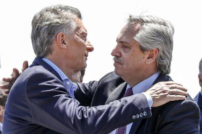 Handout picture released by Alberto Fernandez press office showing Argentine outgoing president Mauricio Macri (L) and President-elect Alberto Fernandez embracing during a mass for unity and peace held at the Minor Basilica of Our Lady of Lujan in Lujan, Buenos Aires, on the Feast of the Immaculate Conception on December 8, 2019. - Macri will hand power over to Fernandez on December 10. (Photo by Esteban COLLAZO / Alberto Fernandez press office / AFP) / RESTRICTED TO EDITORIAL USE - MANDATORY CREDIT "AFP PHOTO / ALBERTO FERNANDEZ PRESS OFFICE / ESTEBAN COLLAZO" - NO MARKETING - NO ADVERTISING CAMPAIGNS - DISTRIBUTED AS A SERVICE TO CLIENTS