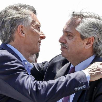 Handout picture released by Alberto Fernandez press office showing Argentine outgoing president Mauricio Macri (L) and President-elect Alberto Fernandez embracing during a mass for unity and peace held at the Minor Basilica of Our Lady of Lujan in Lujan, Buenos Aires, on the Feast of the Immaculate Conception on December 8, 2019. - Macri will hand power over to Fernandez on December 10. (Photo by Esteban COLLAZO / Alberto Fernandez press office / AFP) / RESTRICTED TO EDITORIAL USE - MANDATORY CREDIT "AFP PHOTO / ALBERTO FERNANDEZ PRESS OFFICE / ESTEBAN COLLAZO" - NO MARKETING - NO ADVERTISING CAMPAIGNS - DISTRIBUTED AS A SERVICE TO CLIENTS