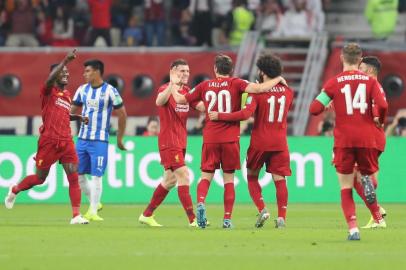 Liverpool players celebrate their opening goal during the 2019 FIFA Club World Cup semi-final football match between Mexicos Monterrey and Englands Liverpool at the Khalifa International Stadium in the Qatari capital Doha on December 18, 2019. (Photo by KARIM JAAFAR / AFP)