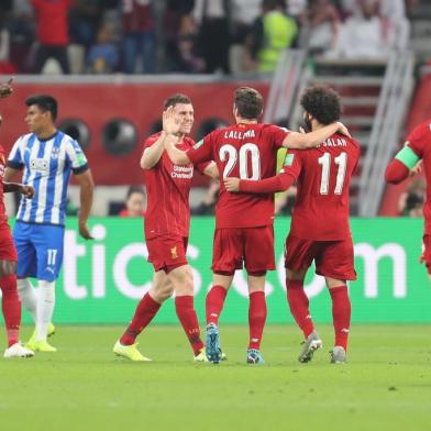 Liverpool players celebrate their opening goal during the 2019 FIFA Club World Cup semi-final football match between Mexicos Monterrey and Englands Liverpool at the Khalifa International Stadium in the Qatari capital Doha on December 18, 2019. (Photo by KARIM JAAFAR / AFP)