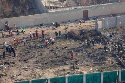 Rescue teams gather at the scene after a Ukrainian plane carrying 176 passengers crashed near Imam Khomeini airport in the Iranian capital Tehran early in the morning on January 8, 2020, killing everyone on board. - All 176 people on board a Ukrainian passenger plane were killed when it crashed shortly after taking off from Tehran on January 8, Iranian state media reported. State news agency IRNA said 167 passengers and nine crew members were on board the aircraft operated by Ukraine International Airlines. (Photo by Rouhollah VAHDATI / ISNA / AFP)