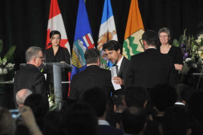 Canadian Prime Minister Justin Trudeau speaks with Albertas Premier Jason Kenney after a memorial service for the victims Ukrainian Airlines flight PS752 crash in Iran at the Saville Community Sports Centre in Edmonton, Canada on January 12, 2020. (Photo by Walter Tychnowicz / AFP)