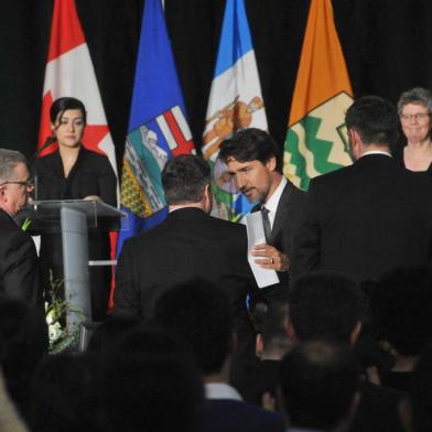 Canadian Prime Minister Justin Trudeau speaks with Albertas Premier Jason Kenney after a memorial service for the victims Ukrainian Airlines flight PS752 crash in Iran at the Saville Community Sports Centre in Edmonton, Canada on January 12, 2020. (Photo by Walter Tychnowicz / AFP)