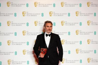 US actor Joaquin Phoenix poses with the award for a Leading Actor for his work on the film Joker at the BAFTA British Academy Film Awards at the Royal Albert Hall in London on February 2, 2020. (Photo by Adrian DENNIS / AFP)<!-- NICAID(14407430) -->