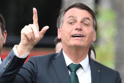 Brazilian President Jair Bolsonaro (R) gestures next to his son, senator Flavio Bolsonaro, during the launch of his new party, the Alliance for Brazil, at a hotel in Brasilia on November 20, 2019. - Bolsonaro left the Social Liberal Party after a disagreement with the party president Luciano Bivar. (Photo by EVARISTO SA / AFP)<!-- NICAID(14333545) -->