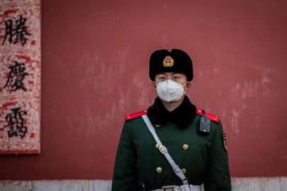 A paramilitary police officer wearing a protective facemask to help stop the spread of a deadly SARS-like virus, which originated in the central city of Wuhan, stands guard at the exit of the Forbidden City in Beijing on January 25, 2020. - China announced it will close a section of the Great Wall and other famous Beijing landmarks to control the spread of the deadly virus that has infected hundreds of people across the country. (Photo by NICOLAS ASFOURI / AFP)<!-- NICAID(14398654) -->