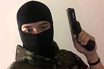 This screenshot made on February 8, 2020 from the Facebook page of Jakrapanth Thomma, a Thai soldier wanted in connection to a deadly attack in the northeastern city of Nakhon Ratchasima, shows him holding a gun at an unknown location. - A Thai soldier killed at least 17 people with over dozen more wounded in a shooting on February 8 in the northeastern city of Nakhon Ratchasima, health authorities said. (Photo by - / Social Media / AFP) / RESTRICTED TO EDITORIAL USE - MANDATORY CREDIT AFP PHOTO /SOCIAL MEDIA - NO MARKETING - NO ADVERTISING CAMPAIGNS - DISTRIBUTED AS A SERVICE TO CLIENTS - NO ARCHIVES<!-- NICAID(14412680) -->