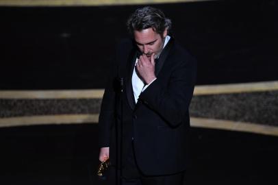 US actor Joaquin Phoenix accepts the award for Best Actor for Joker during the 92nd Oscars at the Dolby Theatre in Hollywood, California on February 9, 2020. (Photo by Mark RALSTON / AFP)<!-- NICAID(14413817) -->