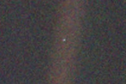 This narrow-angle color image of the Earth, dubbed 'Pale Blue Dot', is a part of the first ever 'portrait' of the solar system taken by Voyager 1. The spacecraft acquired a total of 60 frames for a mosaic of the solar system from a distance of more than 4 billion miles from Earth and about 32 degrees above the ecliptic. From Voyager's great distance Earth is a mere point of light, less than the size of a picture element even in the narrow-angle camera. Earth was a crescent only 0.12 pixel in size. Coincidentally, Earth lies right in the center of one of the scattered light rays resulting from taking the image so close to the sun. This blown-up image of the Earth was taken through three color filters -- violet, blue and green -- and recombined to produce the color image. The background features in the image are artifacts resulting from the magnification.<!-- NICAID(14419758) -->