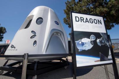 (FILES) In this file photo taken on July 21, 2019 the SpaceX Dragon spacecraft which is designed to carry people and cargo to orbiting destinations such as space stations, is displayed at the SpaceX headquarters in Los Angeles. - SpaceX announced a new partnership February 18, 2020, to send four tourists deeper into orbit than any private citizen before them, in a mission that could take place by 2022 and easily cost more than $100 million. The company signed the deal with Space Adventures, which is based in Washington and served as an intermediary to send eight space tourists to the International Space Station (ISS) via Russian Soyuz rockets. (Photo by Mark RALSTON / AFP)<!-- NICAID(14425426) -->