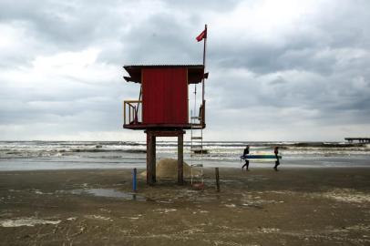 Garoa e temperatura amena deixam o mar de Tramandaí para os surfistas nesta sexta-feira. Na foto, instrutor de surf Jader Vieira com o aluno Mauro Ortiz.<!-- NICAID(14427084) -->