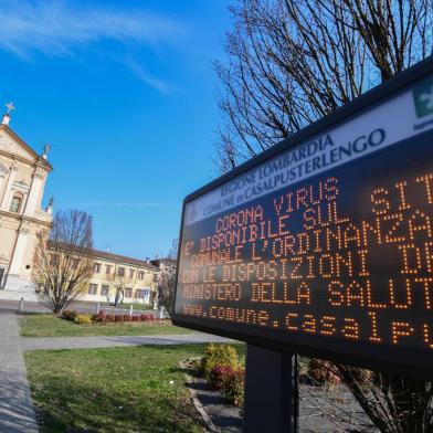 A municipal information sign reads "Coronavirus, the ordinance with the requirements of the Ministry of Health is available on the municipal website" is pictured in the village of Casalpusterlengo, southeast of Milan, on February 22, 2020. - Streets were deserted and residents warned to keep out of an emergency room on February 22, 2020 in the Italian town of Codogno placed under lockdown as a second death from coronavirus sparked fears throughout the region. (Photo by Miguel MEDINA / AFP)<!-- NICAID(14429883) -->