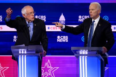 Democratic presidential hopefuls Vermont Senator Bernie Sanders (L) and former Vice President Joe Biden gesture as they participate in the tenth Democratic primary debate of the 2020 presidential campaign season co-hosted by CBS News and the Congressional Black Caucus Institute at the Gaillard Center in Charleston, South Carolina, on February 25, 2020. (Photo by JIM WATSON / AFP)<!-- NICAID(14439795) -->