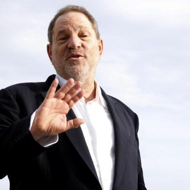 (FILES) This file photo taken on October 5, 2015 shows Harvey Weinstein, US film producer and executive producer of the TV series War and Peace, posing during a photocall at the MIPCOM audiovisual trade fair in Cannes, southeastern France.New York police said on October 12, 2017 they have reopened a investigation into allegations of a 2004 sexual assault by disgraced movie mogul Harvey Weinstein. An avalanche of claims of sexual harassment, assault and rape by the Hollywood heavyweight have surfaced since the publication last week of an explosive New York Times report alleging a history of abusive behavior dating back decades. / AFP PHOTO / VALERY HACHE