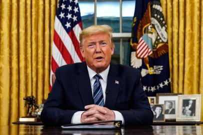 US President Donald Trump addresses the Nation from the Oval Office about the widening novel coronavirus (Covid-19) crisis in Washington, DC on March 11, 2020. - President Donald Trump announced on March 11, 2020 the United States would ban all travel from Europe for 30 days starting to stop the spread of the coronavirus outbreak. To keep new cases from entering our shores, we will be suspending all travel from Europe to the United States for the next 30 days. The new rules will go into effect Friday at midnight, Trump said in an address to the nation. (Photo by Doug Mills / POOL / AFP)<!-- NICAID(14448263) -->