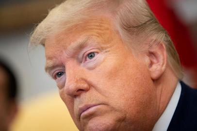 US President Donald Trump listens to questions from the press before a meeting with Irelands Prime Minister Leo Varadkar in the Oval Office of the White House March 12, 2020, in Washington, DC. - US President Donald Trump defended his decision to announce a suspension on arrivals from the EU without informing European governments, telling reporters Thursday there wasnt enough time.His remarks came after the presidents of the European Commission and European Council reacted with anger to the suspension Trump announced unilaterally and without consultation on Wednesday.I didnt want to take time, Trump told reporters in the Oval Office when asked about the criticism. It takes time... We had to move quickly. (Photo by Brendan Smialowski / AFP)<!-- NICAID(14448797) -->