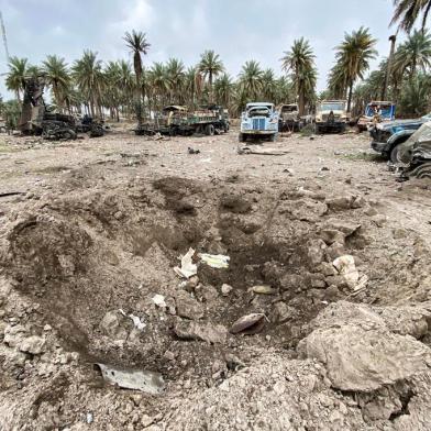 This picture taken on March 13, 2020 shows an impact crater in the aftermath of US military air strikes at a militarised zone in the Jurf al-Sakhr area in Iraqs Babylon province (south of the capital) controlled by Kataeb Hezbollah, a hardline faction of the Hashed al-Shaabi (Popular Mobilisation) forces paramilitaries. - US air strikes targeting pro-Iranian military factions in Iraq killed one civilian and five security personnel early on March 13, the Iraqi military said, warning the raids risked a bloody escalation for the war-battered country. The Pentagon said the strikes were in retaliation for rocket fire against an Iraqi base the night of March 12 that killed one British and two US military personnel in the deadliest such attack in years. (Photo by - / AFP)<!-- NICAID(14450882) -->