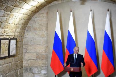 Russian President Vladimir Putin gives a speech during an awards ceremony for those who led the construction of the 19 kilometres (12 miles) road and rail Crimean Bridge over the Kerch Strait - that links mainland Russia to Moscow-annexed Crimea - in Sevastopol, Crimea, on March 18, 2020. (Photo by Alexander NEMENOV / various sources / AFP)<!-- NICAID(14456058) -->