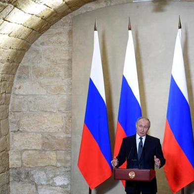 Russian President Vladimir Putin gives a speech during an awards ceremony for those who led the construction of the 19 kilometres (12 miles) road and rail Crimean Bridge over the Kerch Strait - that links mainland Russia to Moscow-annexed Crimea - in Sevastopol, Crimea, on March 18, 2020. (Photo by Alexander NEMENOV / various sources / AFP)<!-- NICAID(14456058) -->