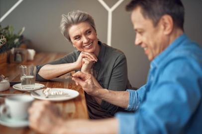 Cheerful aged couple enjoying meeting in cafeEnjoyable meeting. Waist up portrait of cheerful aged woman looking with love to her male friend while enjoying meeting in cafeIndexador: Yaroslav AstakhovFonte: 262787044<!-- NICAID(14408815) -->