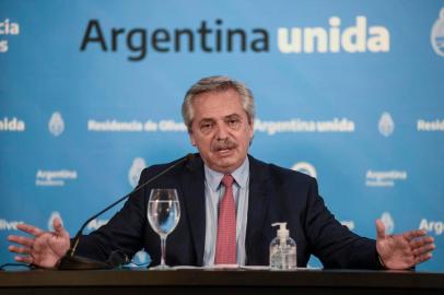 This handout photo released by Argentinas Presidency Press Office on March 29, 2020, shows Argentine President Alberto Fernandez speaking during a conference announcing the new measures and extension of the quarantine during the outbreak of the new Coronavirus, COVID-19, at the presidential residence in Olivos, Buenos Aires. (Photo by - / Argentinas Presidency Press Office / AFP) / RESTRICTED TO EDITORIAL USE - MANDATORY CREDIT AFP PHOTO / ARGENTINAS PRESIDENCY PRESS OFFICE - NO MARKETING - NO ADVERTISING CAMPAIGNS - DISTRIBUTED AS A SERVICE TO CLIENTS<!-- NICAID(14464969) -->