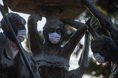  31/03/2020 - NOVA PETRÓPOLIS - Ação promovida por médico, com apoio da Secretaria Municipal de Saúde e Assistência Social, coloca máscaras em estátuas do Monumento do Cooperativismo, localizado na Praça das Flores, bem no centro de Nova Petrópolis, para conscientizar a população sobre o coronavírus. O simbolismo se deve a fato de Nova Petrópolis ser a Capital Nacional do Cooperativismo, característica fundamental nesses tempos de pandemia de coronavírus.Indexador: Mauro Stoffel<!-- NICAID(14466113) -->