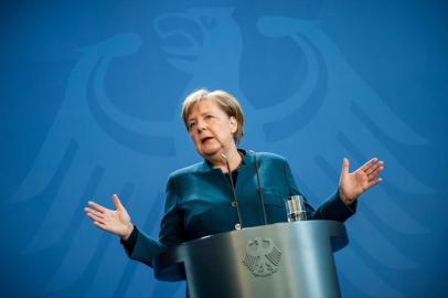 (FILES) In this file photo taken on March 22, 2020 German Chancellor Angela Merkel makes a press statement on the spread of the new coronavirus COVID-19 at the Chancellery in Berlin. (Photo by Michael Kappeler / POOL / AFP)<!-- NICAID(14468294) -->