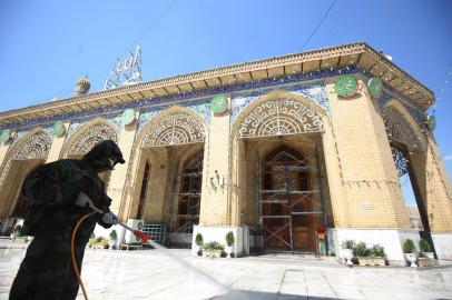 Members of the Iraqi civil defence disinfect the mausoleum of Imam Abu Hanifa al-Numan in Baghdads Sunni Muslim district of Aadhamiya on April 13, 2020, as a precaution against the spread of the coronavirus COVID-19 during a curfew imposed on the Iraqi capital. (Photo by AHMAD AL-RUBAYE / AFP)