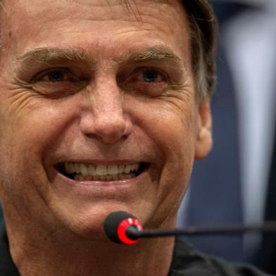 Brazils right-wing presidential candidate for the Social Liberal Party (PSL) Jair Bolsonaro gestures during a press conference in Rio de Janeiro, Brazil on October 11, 2018. - The far-right frontrunner to be Brazils next president, Jair Bolsonaro, stumbled Wednesday by spooking previously supportive investors, while a spate of violent incidents pointed to deep polarization caused by the election race. (Photo by Mauro Pimentel / AFP)<!-- NICAID(13781822) -->