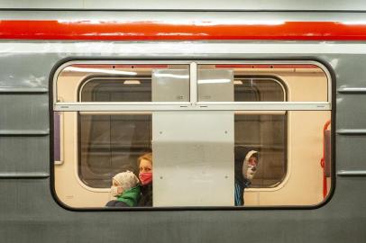 Passengers, wearing face masks, sit in a train at a subway station in Prague on April 15, 2020 amid restrictions due to the new coronavirus pandemic. (Photo by Michal Cizek / AFP)<!-- NICAID(14478494) -->